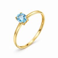 Anillo de oro amarillo 18k con topacio azul ovalado
