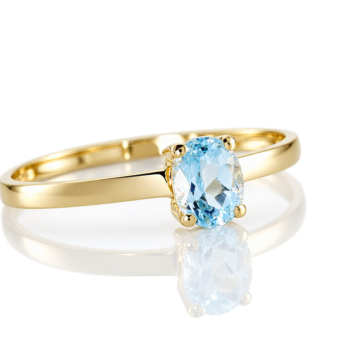 Anillo de oro amarillo 18k con topacio azul ovalado